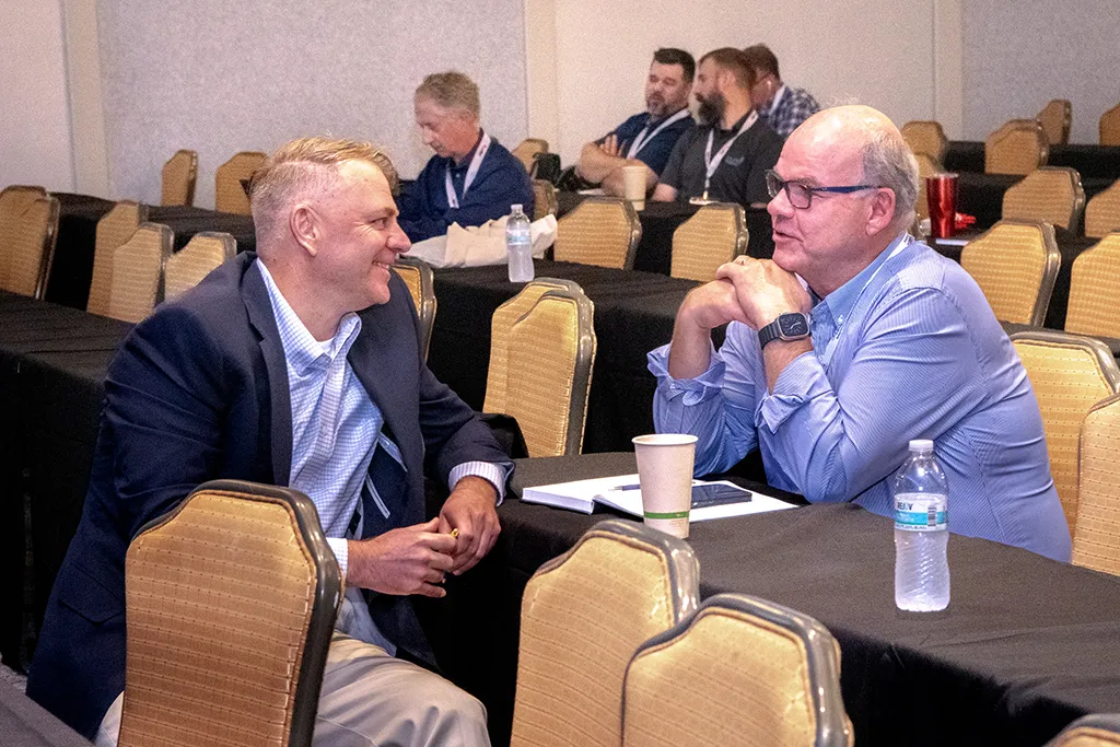 Two men talking at Membrane Technology Forum